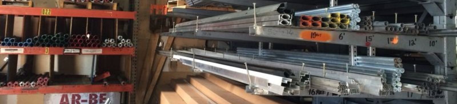 Organized shelves of garage door springs, tracks, and hardware in a Magna, UT workshop, showcasing the materials used for professional garage door installations and repairs.